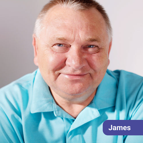 Man wearing a light blue shirt with a name tag labeled 'James' on a plain background