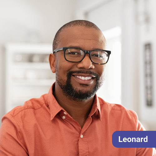 Man wearing glasses and an orange shirt, with a name tag labeled 'Harold' on a blurred background.